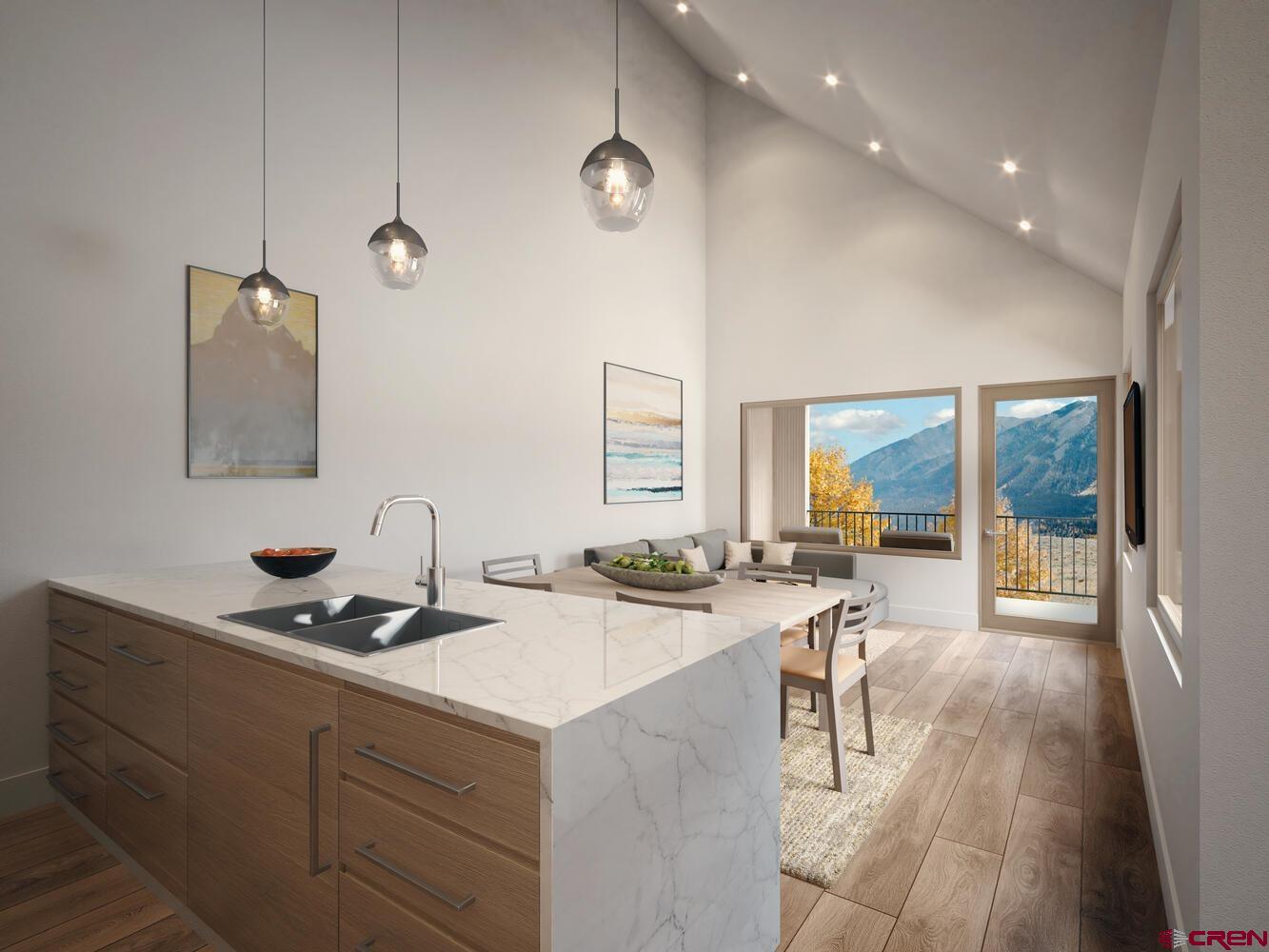 231 Elk Valley Road, Unit 2B Crested Butte, CO 81224 - Photo 3 of 9 a kitchen with a sink a counter top space and living room area