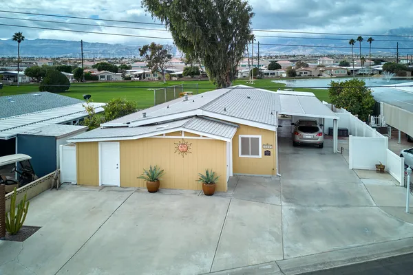 an aerial view of a house with garden space and parking