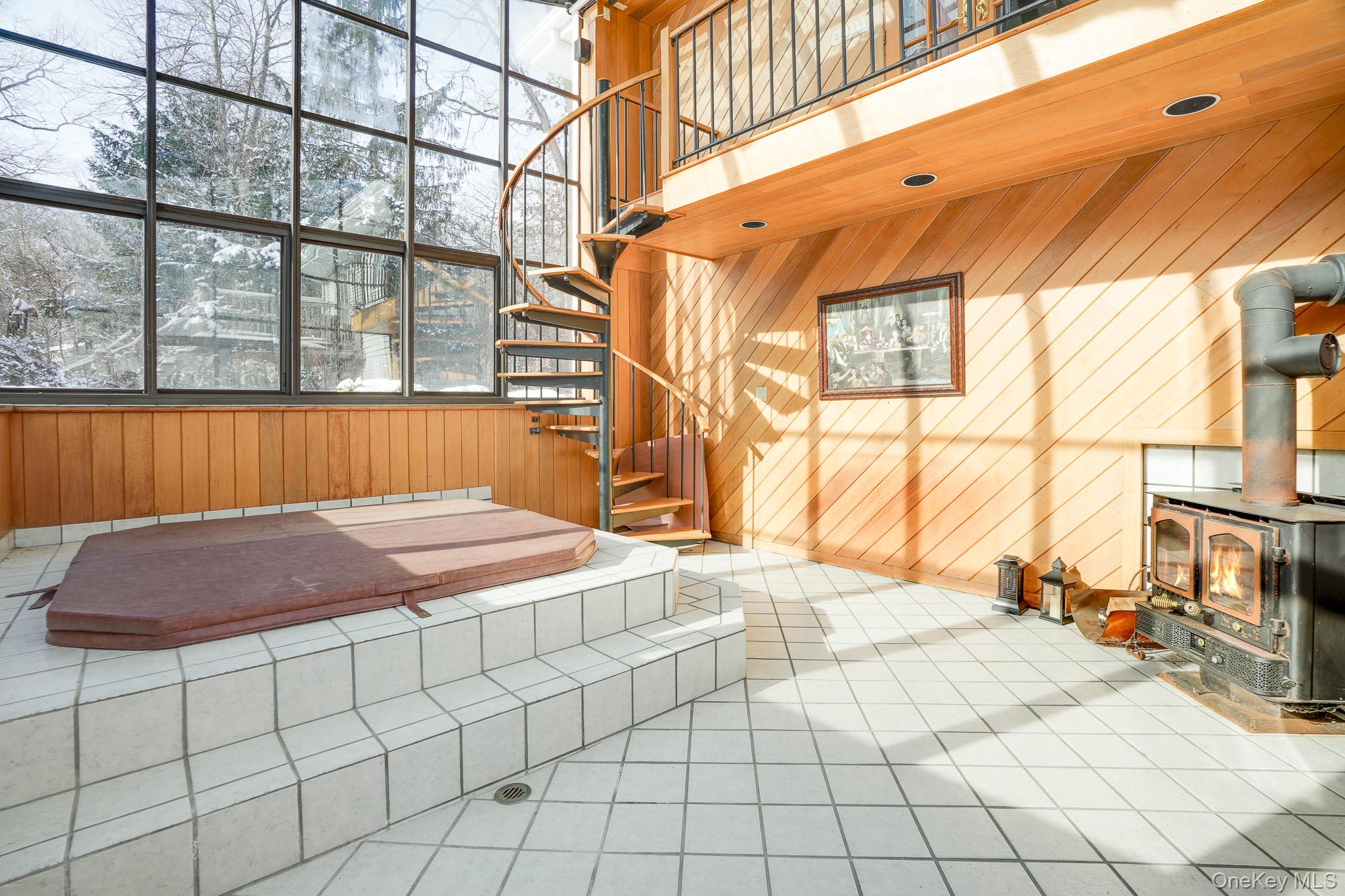 53 Tanager Road Mahopac, NY 10541 - Photo 17 of 41 Spiral stairs leading to the hot tub and pellet stove.