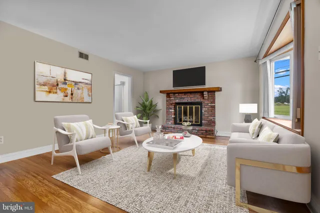 a living room with furniture a rug and a fireplace