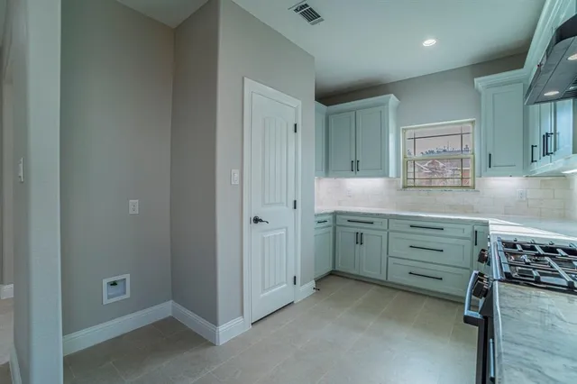 a room with a cabinets and a dresser