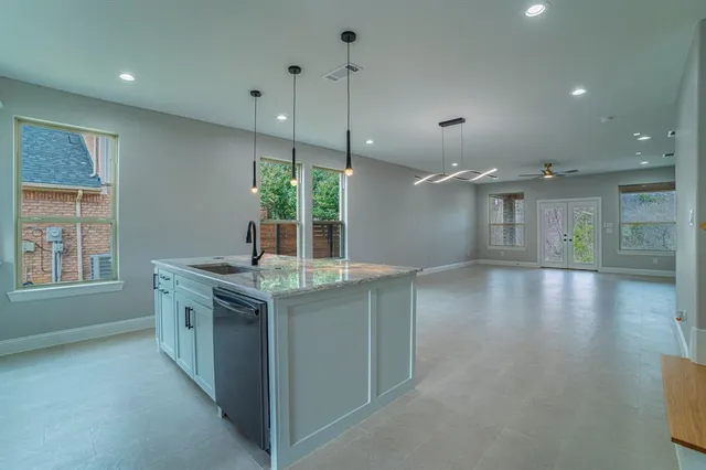 a kitchen with stainless steel appliances granite countertop a stove and a wooden floors