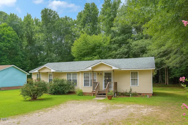 a front view of a house with a yard table and chairs
