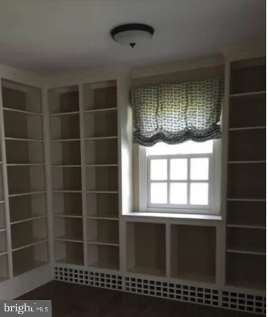 a view of wooden floor and windows in a room