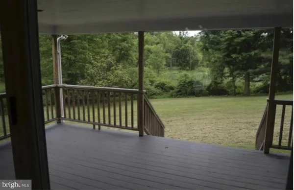 a view of a balcony with wooden floor