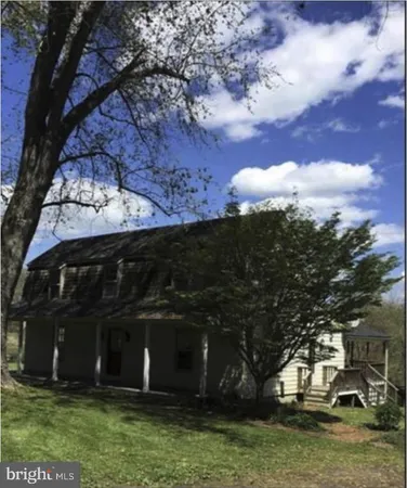 a view of house with a yard
