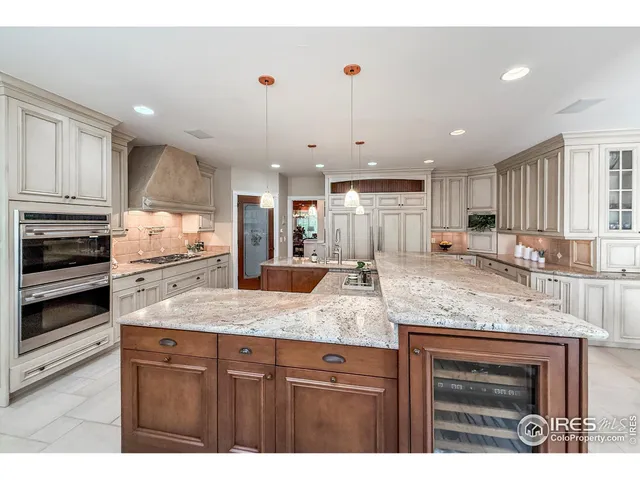 a living room with furniture a fireplace and a large window