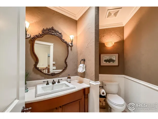 a living room with furniture a chandelier and a flat screen tv
