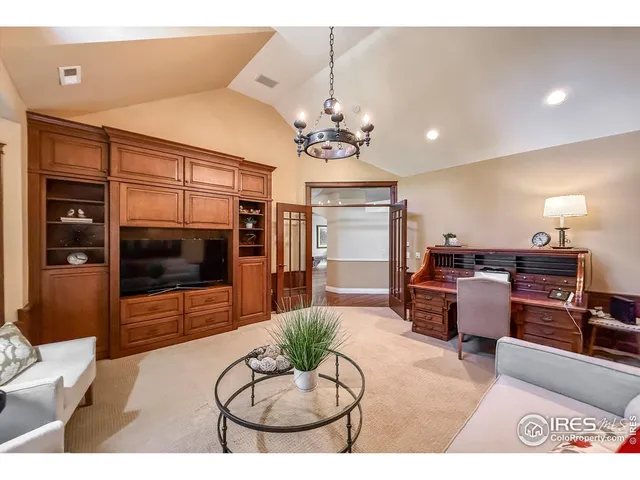 a bedroom with furniture and a flat screen tv