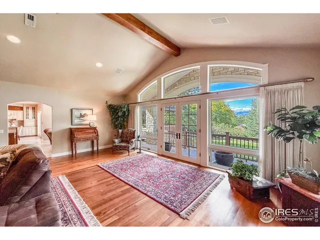 a large kitchen with a large counter top space a sink stainless steel appliances and cabinets