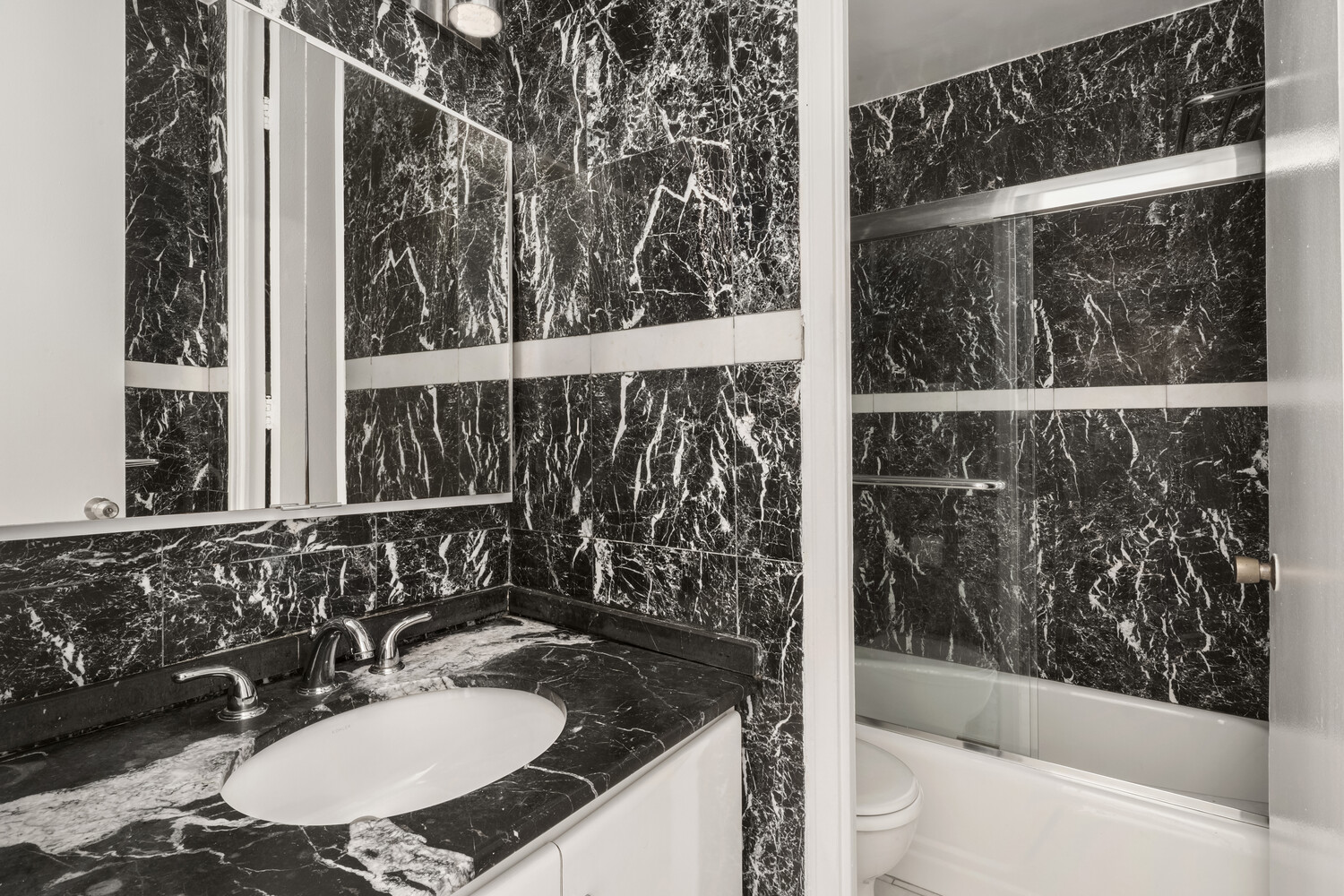 300 East 40th Street, Unit 21V Manhattan, NY 10016 - Photo 5 of 7 a bathroom with a sink and a mirror