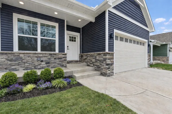 a front view of a house with garden