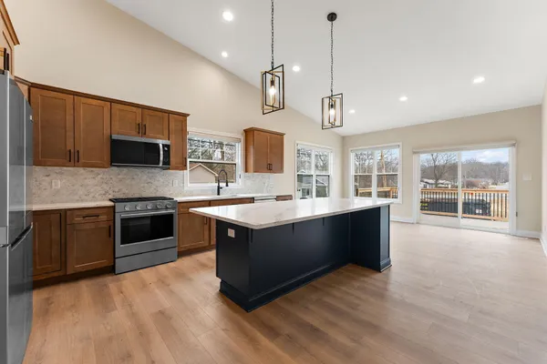 a kitchen with stainless steel appliances a sink stove and refrigerator