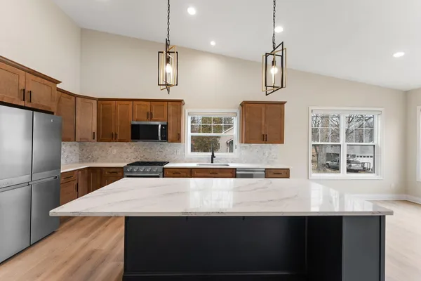 a large kitchen with stainless steel appliances kitchen island a large island in the center