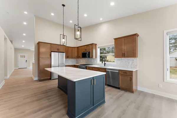 a kitchen with a sink stove and refrigerator