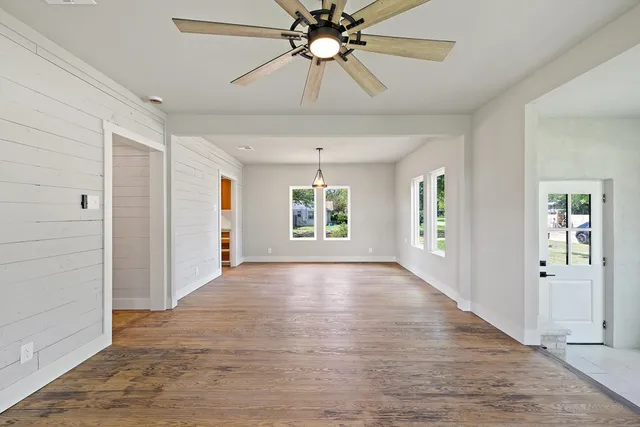 wooden floor in an empty room with a window