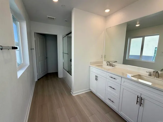 a bathroom with a shower and a glass door