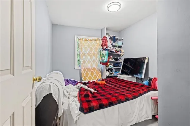 a bedroom with bed and a window