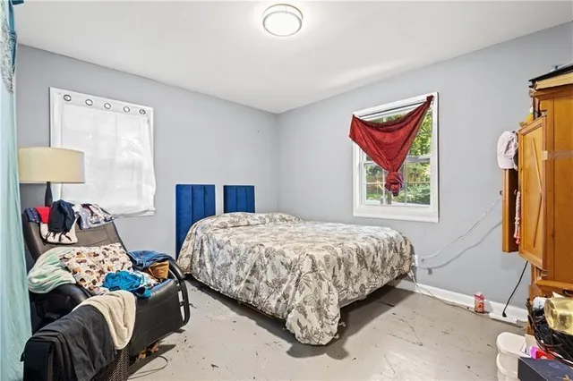 a bedroom with bed and a window