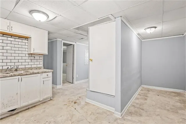 a bathroom with a granite countertop sink a mirror and a shower