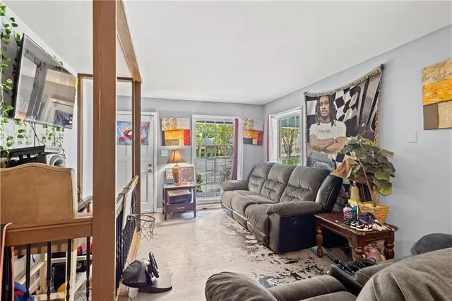 a living room with furniture and a floor to ceiling window