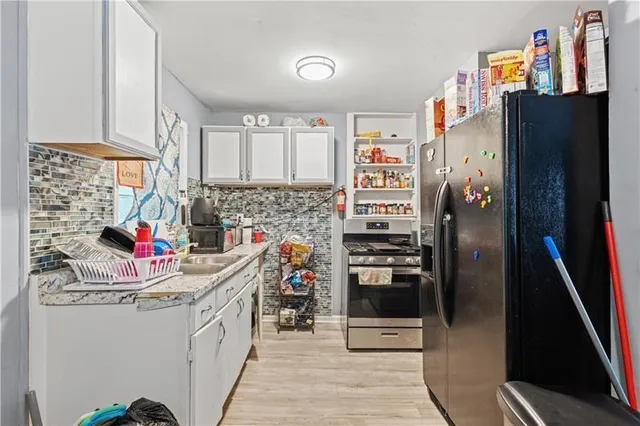 a kitchen with a refrigerator and cabinets