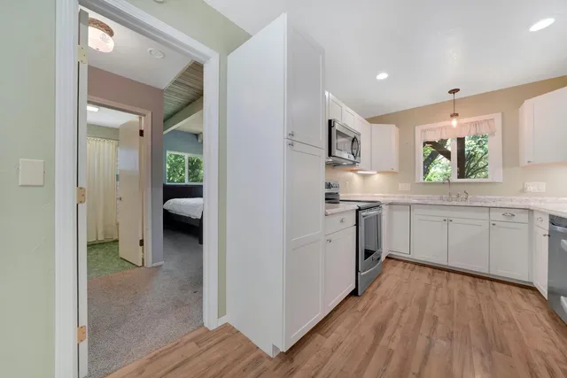 a kitchen with a refrigerator and a sink