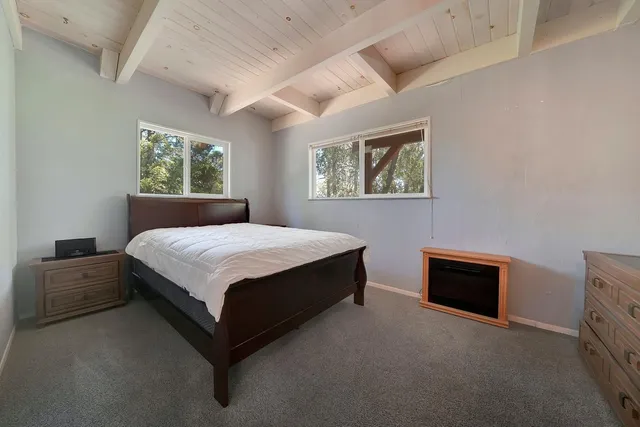 a spacious bedroom with a bed and a couch