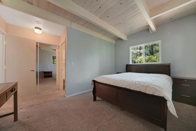 a bedroom with a bed and window