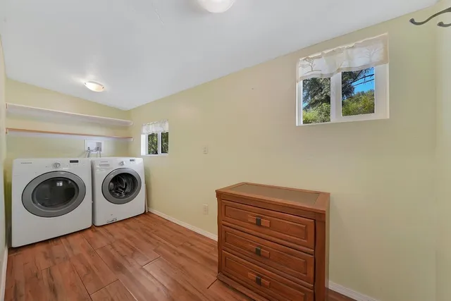 a view of a bedroom with washer and dryer