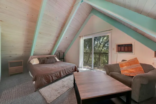 a bedroom with furniture and a large window