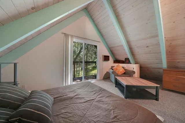 a bedroom with a bed and a large window