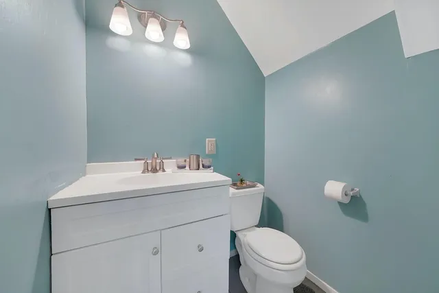 a bathroom with a sink a toilet and a mirror