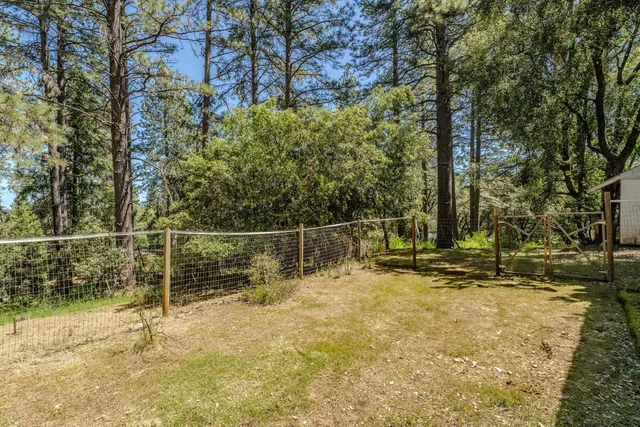 a backyard of a house with table and chairs