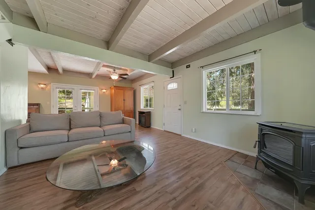 a living room with furniture wooden floor and a fireplace
