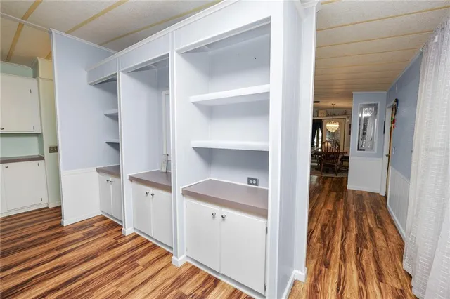 a kitchen with stainless steel appliances granite countertop a sink stove a refrigerator and a oven with wooden floor