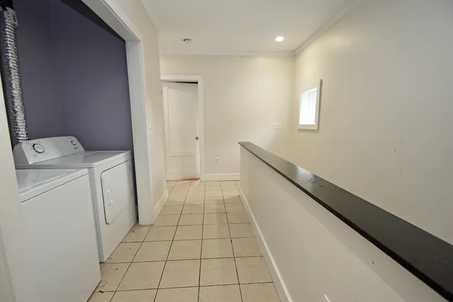 a hallway with a washer and dryer