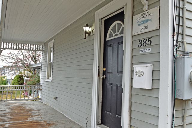 a view of a door and brick walls