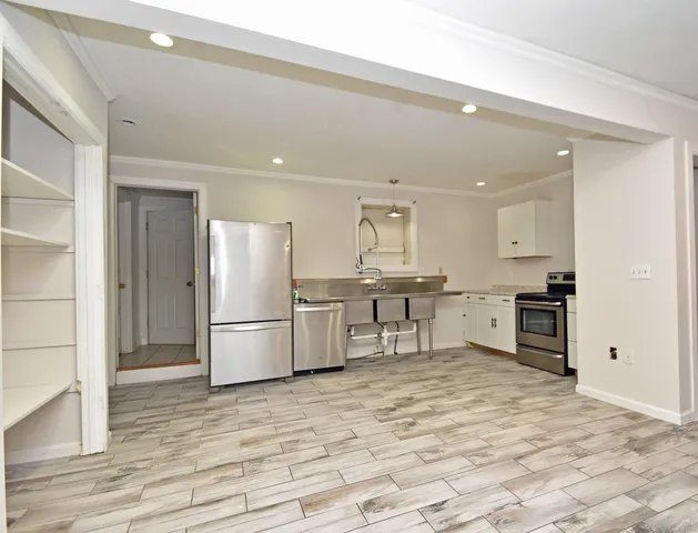 a kitchen with stainless steel appliances a refrigerator and a stove top oven