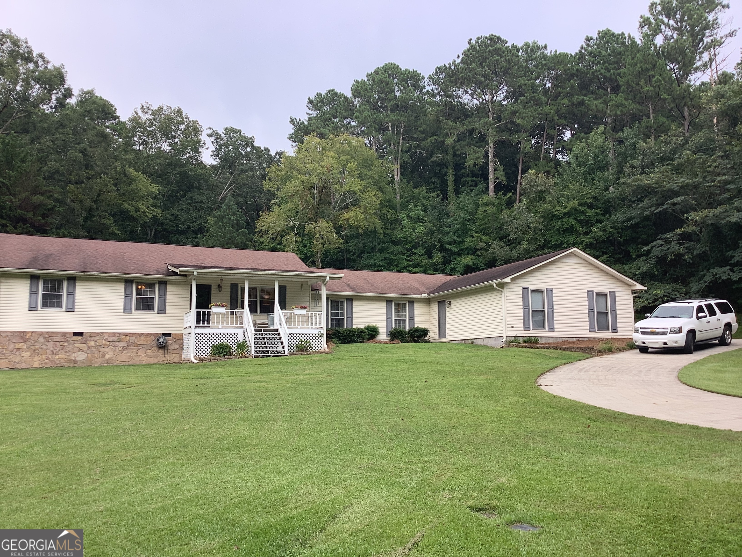 334 Armuchee Trail Northeast Rome, GA 30165 - Photo 2 of 53 a view of a house with a big yard and large trees