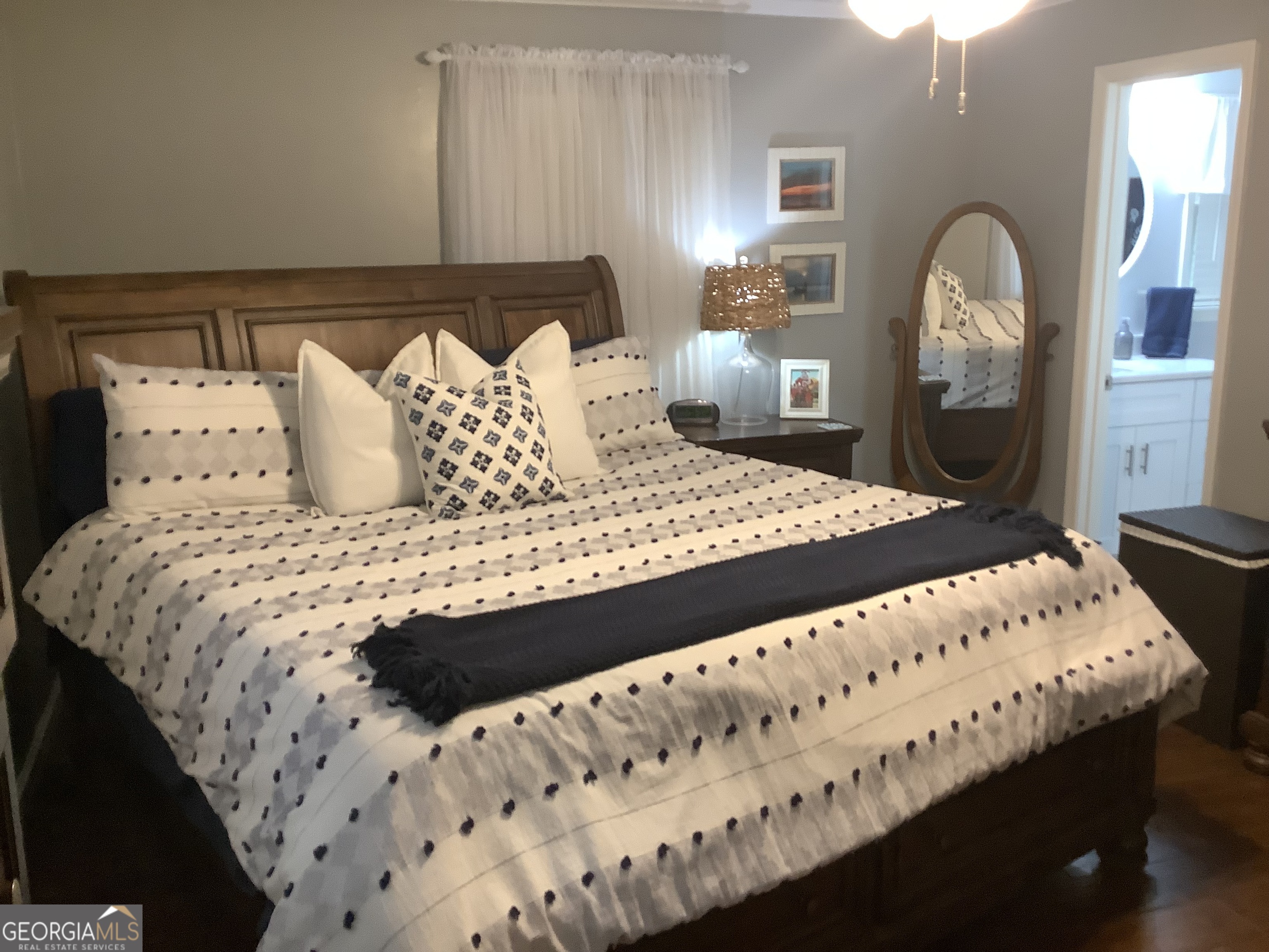 334 Armuchee Trail Northeast Rome, GA 30165 - Photo 31 of 53 a large bed sitting in a bedroom next to a window with lamp and dresser