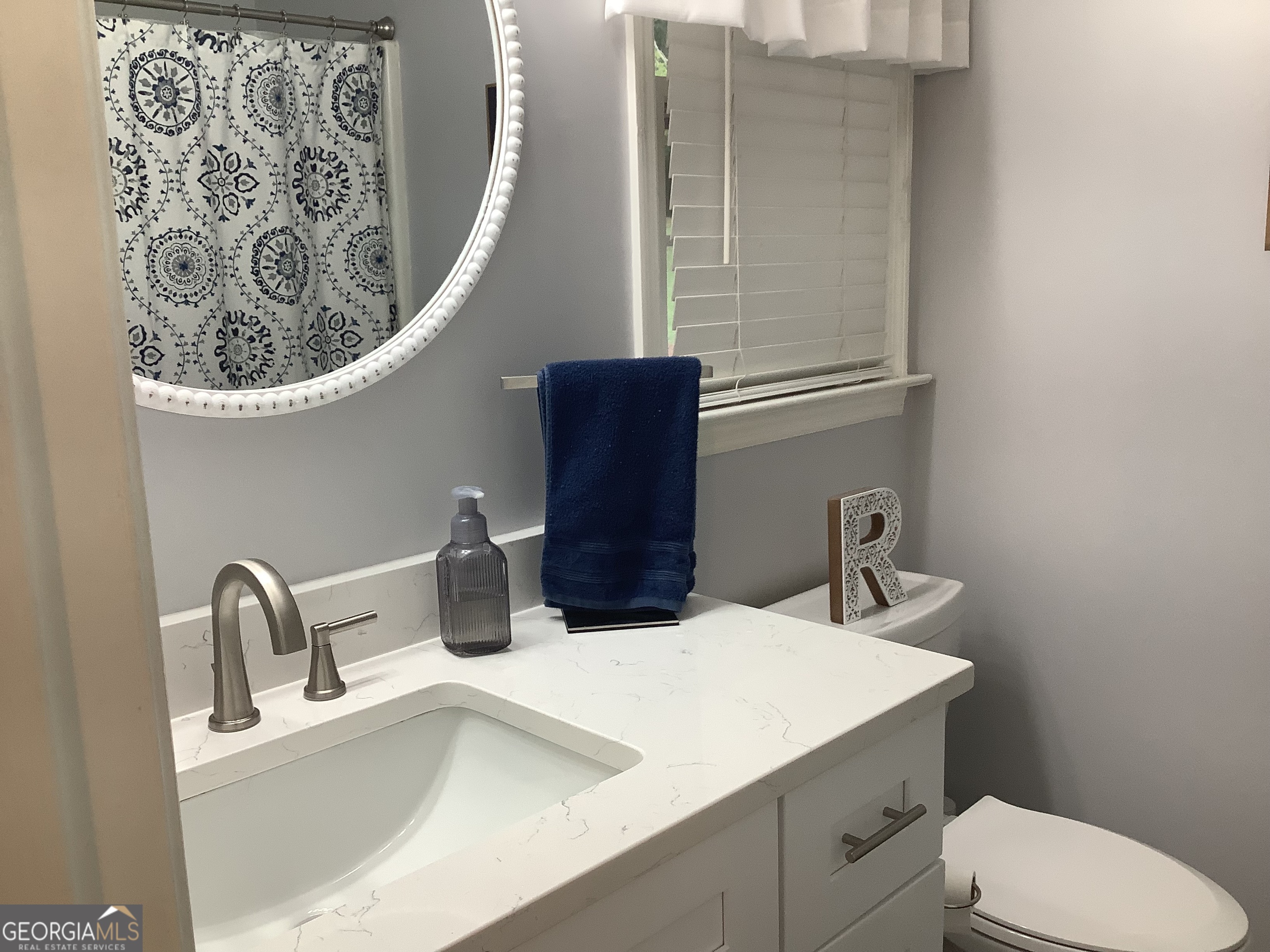334 Armuchee Trail Northeast Rome, GA 30165 - Photo 32 of 53 a bathroom with a toilet sink and mirror