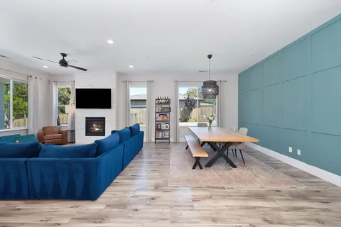 a living room with fireplace furniture and a flat screen tv