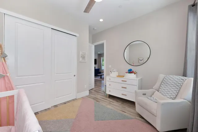 a bedroom with furniture and a large window