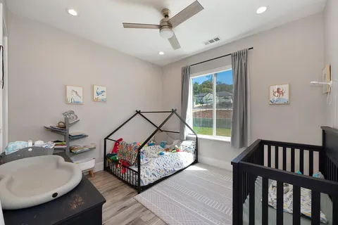 a bathroom with a granite countertop sink mirror vanity and toilet