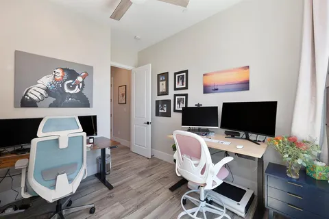 a bedroom with a bed and wooden floor
