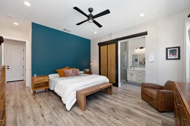 a bedroom with furniture and a flat screen tv