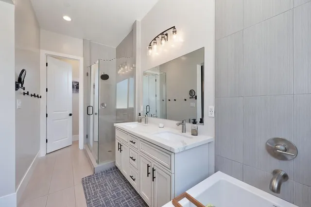 a bathroom with a shower sink and mirror