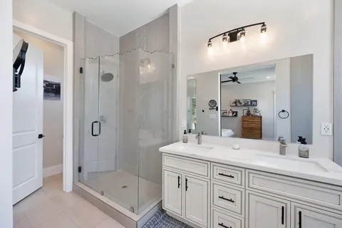 a bathroom with a tub sink and mirror