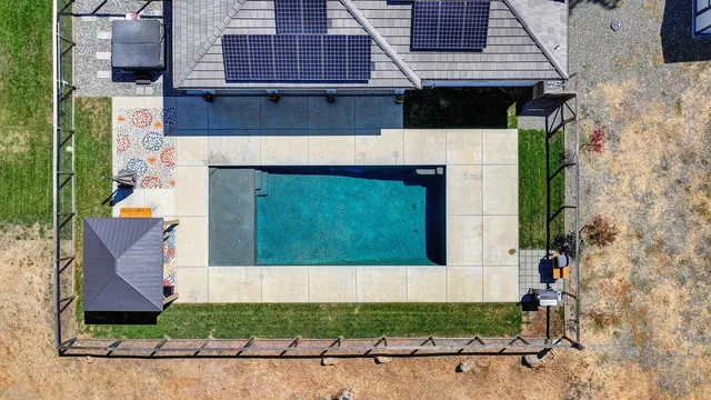 a view of house with swimming pool outdoor seating